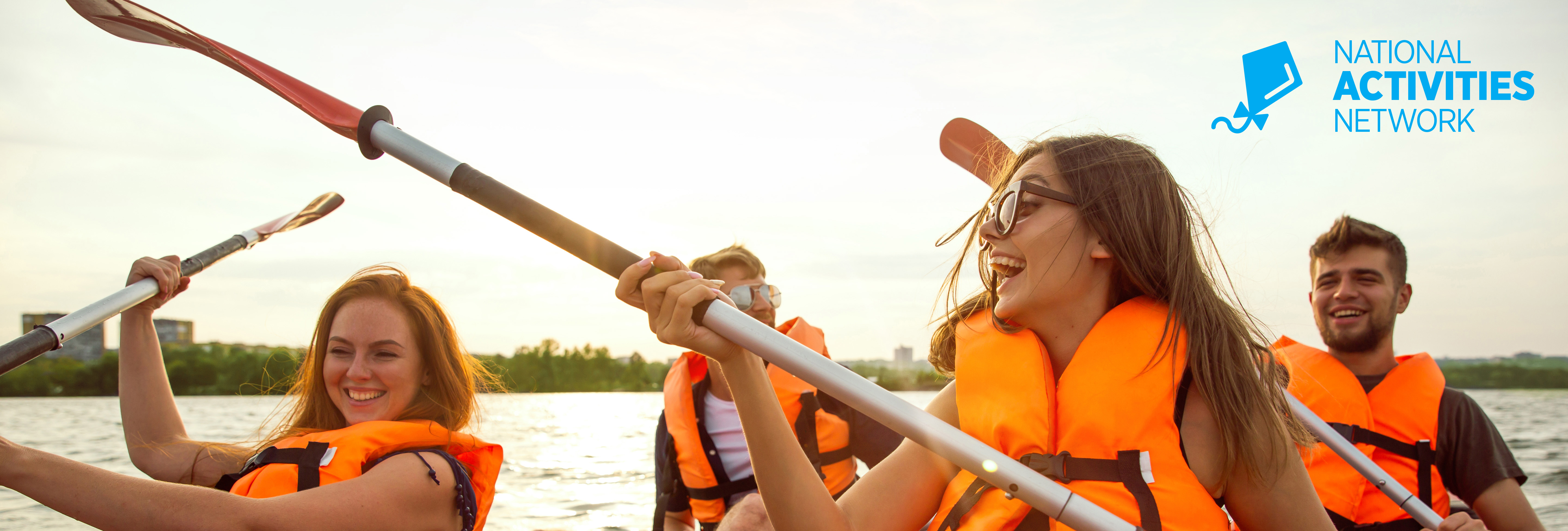 happy-friends-kayaking-river-with-sunset-background